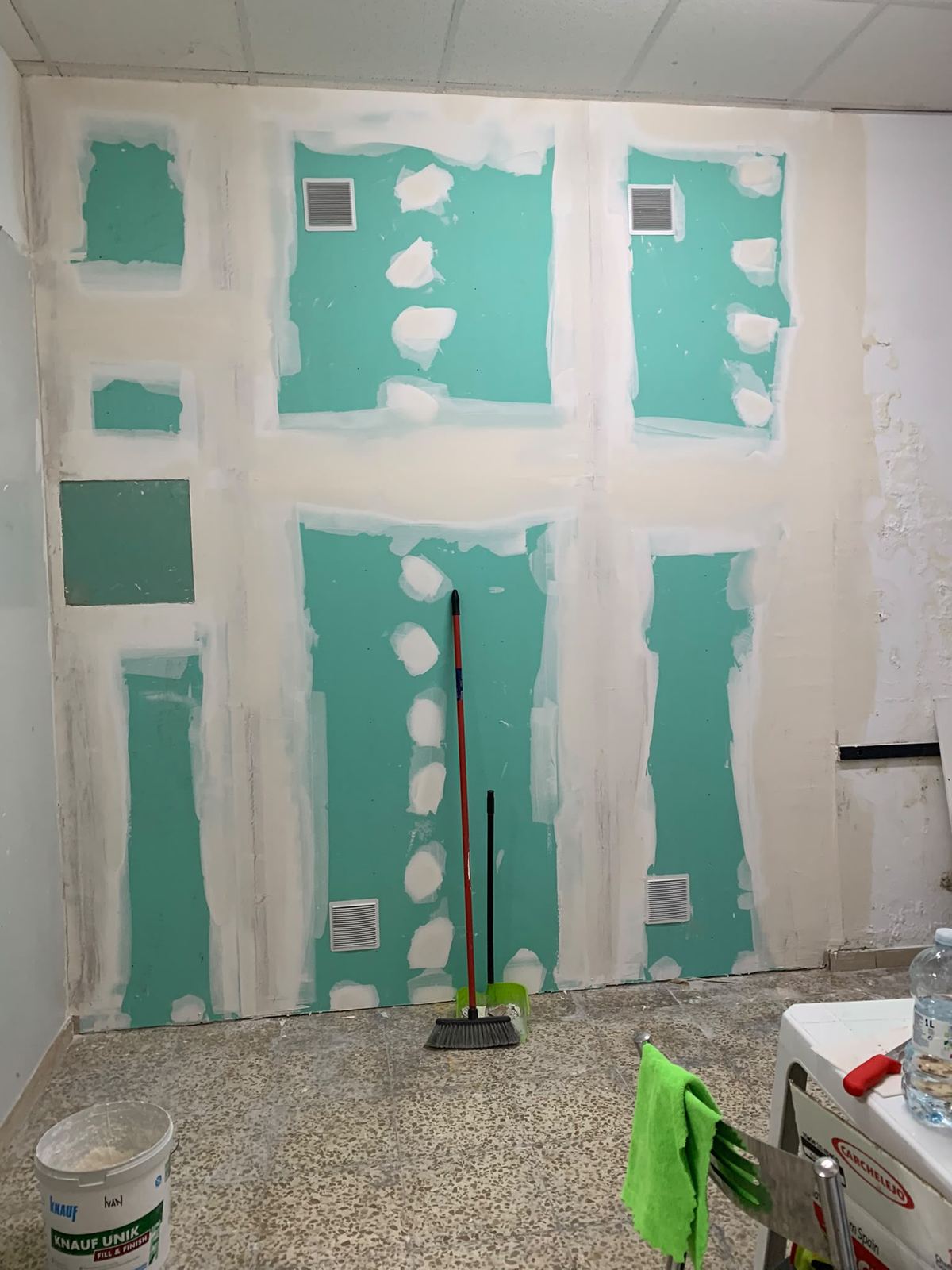 La misma pared trasdosada con placa hidrófuga verde, juntas emplastecidas y rejillas de ventilación